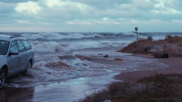 Bilen parkerad och fast vid havet stranden under kraftig storm — Stockvideo