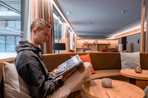 Man Reading Travel Magazine While Sitting Lobby Young Male Looking — Stock Photo, Image