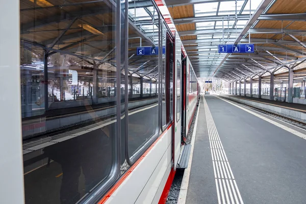 stock image Close-up of train arrived on platform. Reflection on locomotive railroad vehicle reached at station. Mode of transport in alpine region.