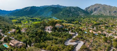 Aerial view of Pollenca, Mallorca, Spain. Small town with a view into a green and rocky landscape.