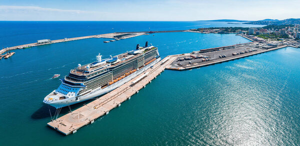 A large cruise ship moored at the port of Palma de Mallorca at daytime. The huge cruise ships bringing tourists for one day to look at the town