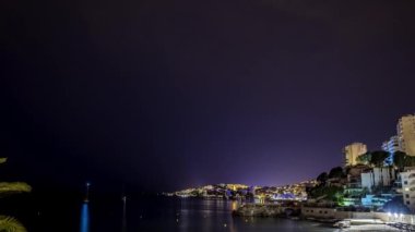 Timelapse of the starry night over touristic beach town. Stars timelapse view.