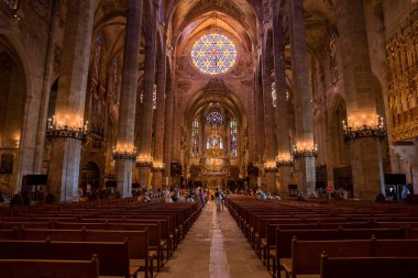 Mallorca, İspanya. 27 Nisan 2022. Gotik La Seu Katedrali 'ni ziyaret eden insanların içinde. Şehirdeki ortaçağ kilisesinde leke camlar ve sıralar vardı. Tarihi ruhani bir yer..