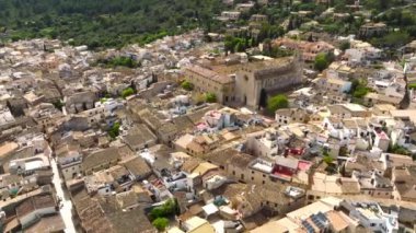 Aerial view of Pollenca, Mallorca, Spain. Small town with a view into a green and rocky landscape.