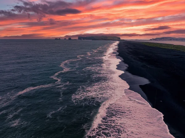 Iceland black sand beach with huge waves at Reynisfjara Vik. Aerial cinematic 4k video. Beautiful Iceland nature coastline from above.
