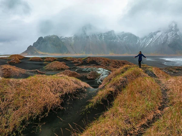 ストックスネス岬とアイスランドのヴェストラホーン山の近くの嵐のアイスランドを探索する若い女の子 — ストック写真