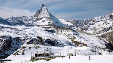 Zermatt 'taki Matterhorn Dağı' ndan geçen tren. Demiryolu aracı Gornergrat istasyonuna doğru koşuyor. Kış boyunca Alpler 'deki mavi gökyüzü karla kaplıydı..