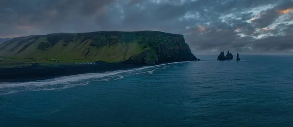 Iceland black sand beach with huge waves at Reynisfjara Vik. Aerial cinematic 4k video. Beautiful Iceland nature coastline from above.