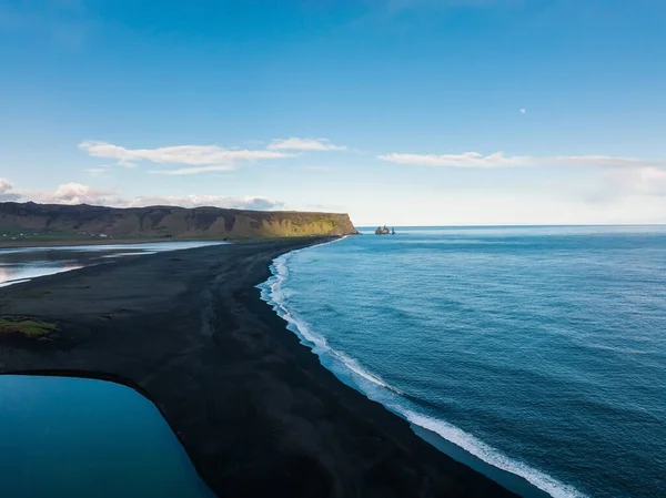 Iceland black sand beach with huge waves at Reynisfjara Vik. Aerial cinematic 4k video. Beautiful Iceland nature coastline from above.