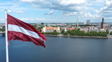 Kubbe Katedrali ile Letonya bayrağının yavaş hareketi ve Riga, Letonya, Baltık ülkeleri arka planında eski bir kasaba