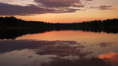 Colorful sky and colorful water in lake reflected in the evening sunset. Magical nature.