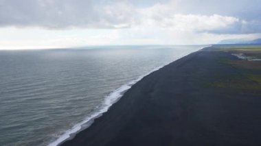 Iceland black sand beach waves near Reynisfjara Vik. Beautiful nature in Iceland.