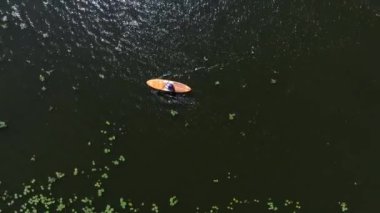 Aerial drone birds eye view of young woman practising paddle board or sup in tropical Caribbean sapphire crystal clear calm waters