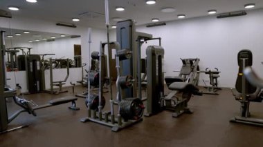 Design and equipment in modern gym. Modern of gym interior with equipment. Sports equipment in the gym Barbells of different weight on rack.