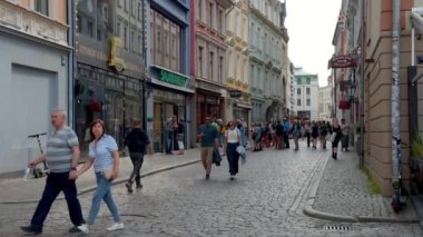 Beautiful summer day in Riga. People and tourists exploring old town of Riga, Latvia.