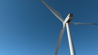 Panoramic aerial view of wind farm or wind park, with high wind turbines for generation electricity. Green energy concept.