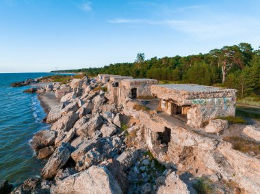 Ruins of bunkers on the beach of the Baltic sea, part of an old fort in the former Soviet base Karosta in Liepaja, Latvia. Sunset landscape.