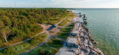 Ruins of bunkers on the beach of the Baltic sea, part of an old fort in the former Soviet base Karosta in Liepaja, Latvia. Sunset landscape.