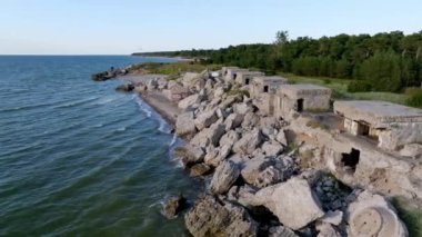 Ruins of bunkers on the beach of the Baltic sea, part of an old fort in the former Soviet base Karosta in Liepaja, Latvia. Sunset landscape.