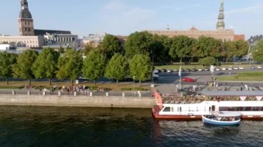 Small cruise ship taking tours down the river Daugava in Riga, Latvia right next to the old town of Riga.