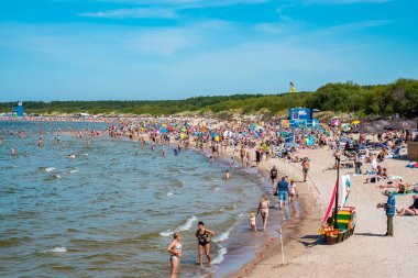 Crowded beach in Palanga, Lithuania. People enjoying summer time by the Baltic sea in Palanga.