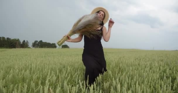 Girl In A Straw Hat Walks On A Wheat Field. — Stock Video