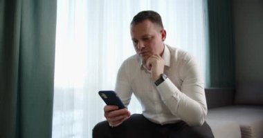 Business man browsing information on the phone