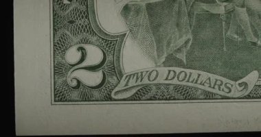 Two US dollars cash macro view. 2 cash. Under a magnifying glass.
