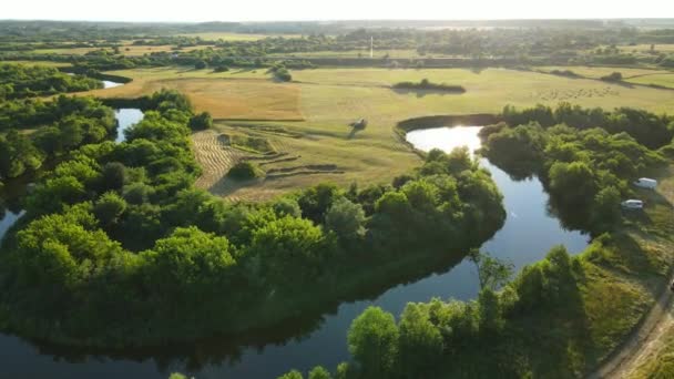 Het platteland. Een brede rivierbedding, stromend tussen velden en bossen — Stockvideo