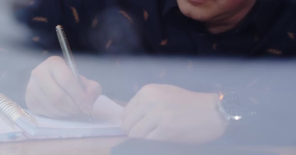 Focused man writes a letter while sitting in a cafe — Stock Video