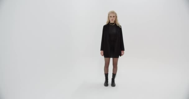 Young Girl Model In A Black Dress Posing For A Photo In The Studio — Stock video