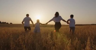 dad and mom are having fun playing with children in nature