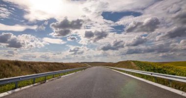 Tarlanın ortasında boş bir araba yolu var.
