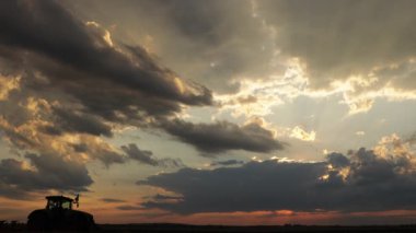The movement of thick rain clouds across the sky