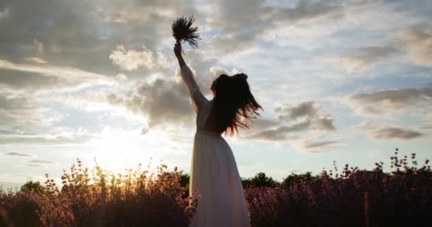 Girl Holds Bouquet Lavender Flowers Her Hands Background Sky — Stockvideo