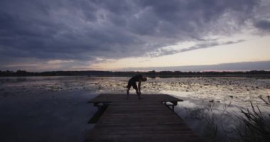 A person does yoga, stretching all muscle groups