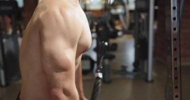 Man pulling rope with hands, training upper body, chest, shoulders, pectoral muscles, triceps, bodybuilding, weight, strength.