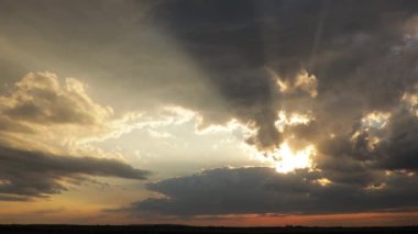 The movement of thick rain clouds across the sky
