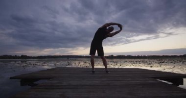 A person does yoga, stretching all muscle groups
