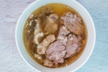 Galbitang, Korean style beef Short Rib Soup : Beef ribs, soaked in cold water to remove the blood, and white radish chunks simmered together until tender. The clear stock is rich and savory, and the tender meat falls off the bone. (Glass noodles may 