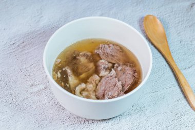 Galbitang, Korean style beef Short Rib Soup : Beef ribs, soaked in cold water to remove the blood, and white radish chunks simmered together until tender. The clear stock is rich and savory, and the tender meat falls off the bone. (Glass noodles may 