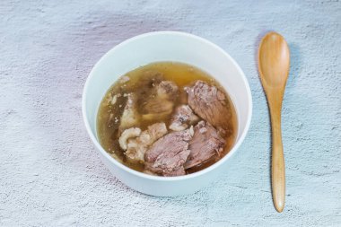 Galbitang, Korean style beef Short Rib Soup : Beef ribs, soaked in cold water to remove the blood, and white radish chunks simmered together until tender. The clear stock is rich and savory, and the tender meat falls off the bone. (Glass noodles may 