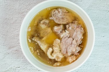 Galbitang, Korean style beef Short Rib Soup : Beef ribs, soaked in cold water to remove the blood, and white radish chunks simmered together until tender. The clear stock is rich and savory, and the tender meat falls off the bone. (Glass noodles may 