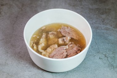 Galbitang, Korean style beef Short Rib Soup : Beef ribs, soaked in cold water to remove the blood, and white radish chunks simmered together until tender. The clear stock is rich and savory, and the tender meat falls off the bone. (Glass noodles may 