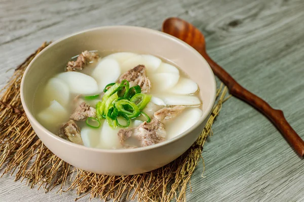 Tteokguk, Korean Sliced Rice Cake Soup : Oval-shaped rice cake cooked in broth. A traditional Lunar New Year dish. Clear beef broth is most commonly used, but chicken or seafood may be added.