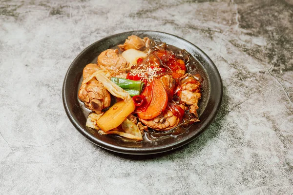Andongjjimdak, Korean Braised Chicken : To make this dish, chicken is cut into pieces and braised with carrot, potato, and other vegetables, along with a soy sauce-based seasoning.