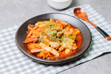 Korean food Stir-fried Squid, ojingeobokkeum : Squid stir-fried with onions, carrots, and cabbage in a spicy mixture of gochujang and red chili powder.
