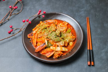 Korean food Stir-fried Squid, ojingeobokkeum : Squid stir-fried with onions, carrots, and cabbage in a spicy mixture of gochujang and red chili powder.
