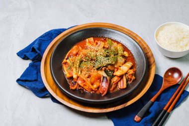 Korean food Stir-fried Squid, ojingeobokkeum : Squid stir-fried with onions, carrots, and cabbage in a spicy mixture of gochujang and red chili powder.
