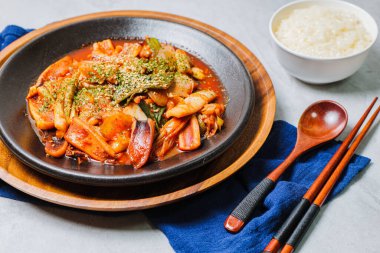 Korean food Stir-fried Squid, ojingeobokkeum : Squid stir-fried with onions, carrots, and cabbage in a spicy mixture of gochujang and red chili powder.